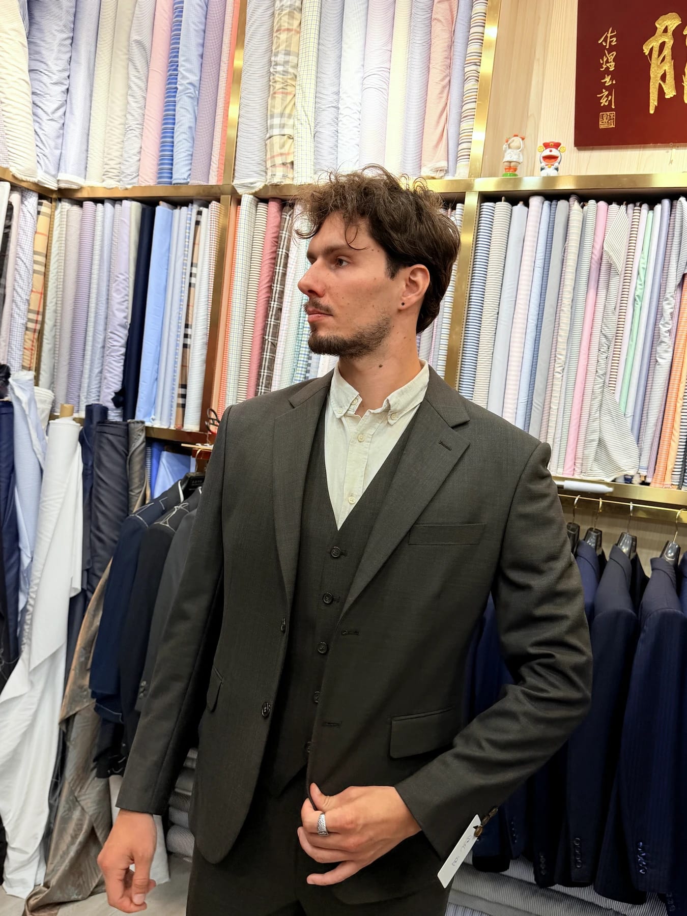 Three-quarter view of a finished grey three-piece suit inside Wuyue Shanghai